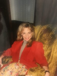 Woman smiling seated with red petycoat